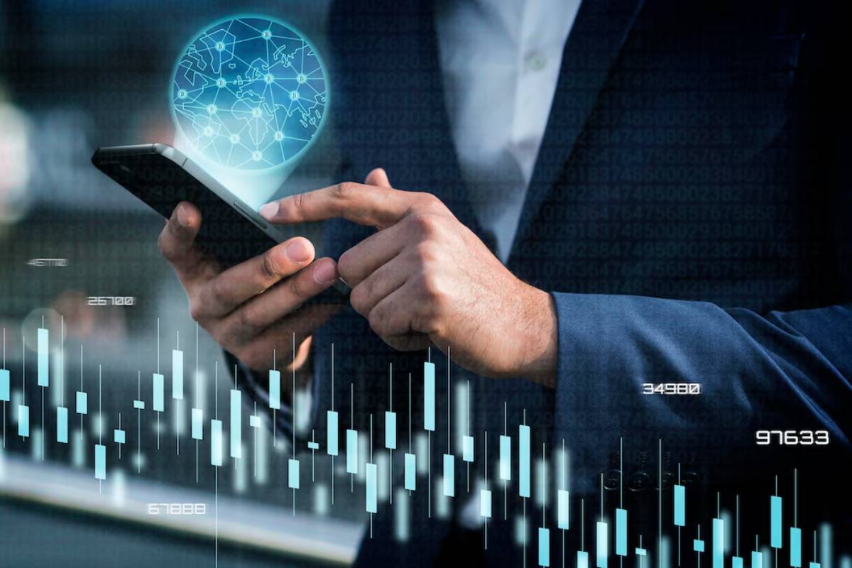 Businessman using smartphone displaying global network and data charts, highlighting digital communication and analytics.