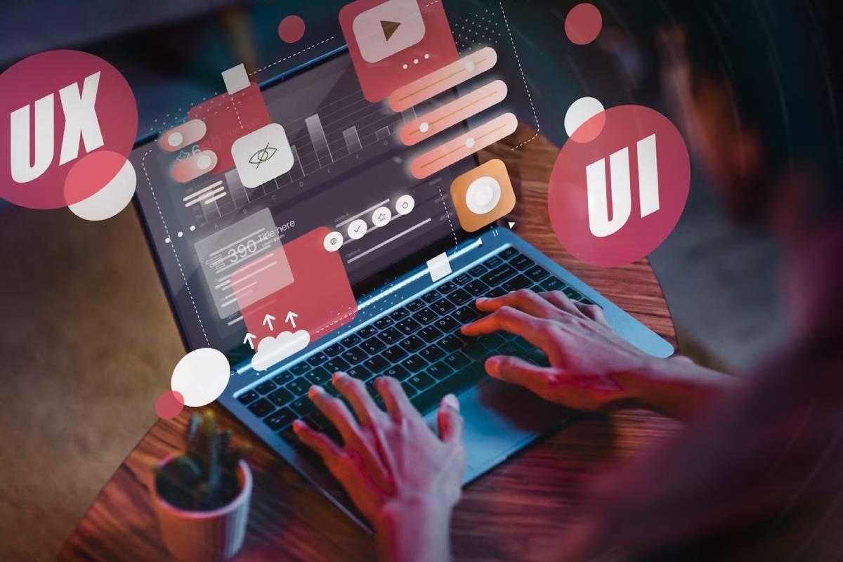 Person using a laptop with floating digital icons labeled for user interface design concepts.