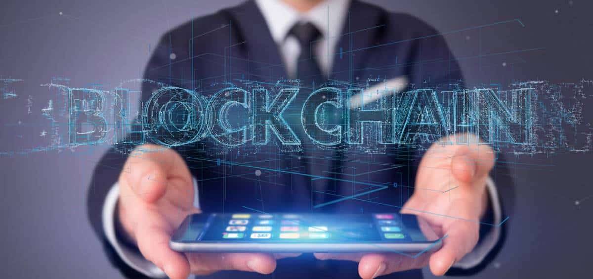Graphic of an eye-shaped design with AI & BLOCKCHAIN text, symbolizing technology and futuristic concepts on a dark hexagonal background.
