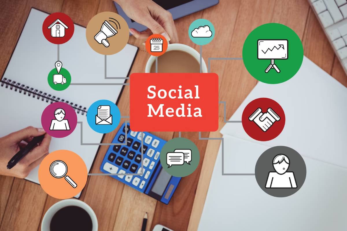 Top-down view of a person working at a desk, surrounded by icons representing various social media functions like networking and communication.