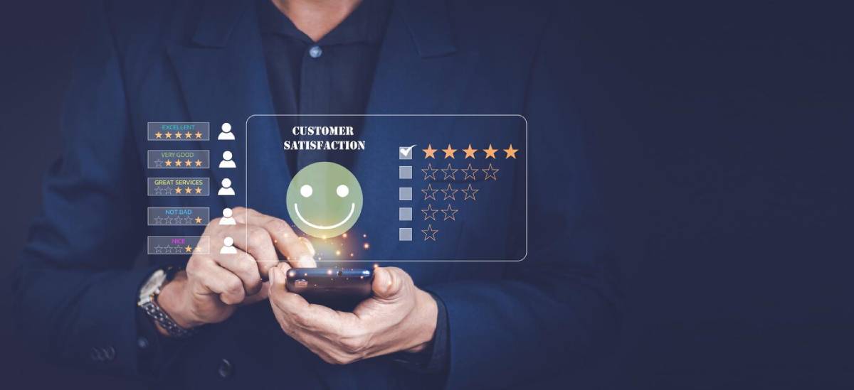 Businessman using smartphone displaying customer satisfaction and rating interface with five-star review system.