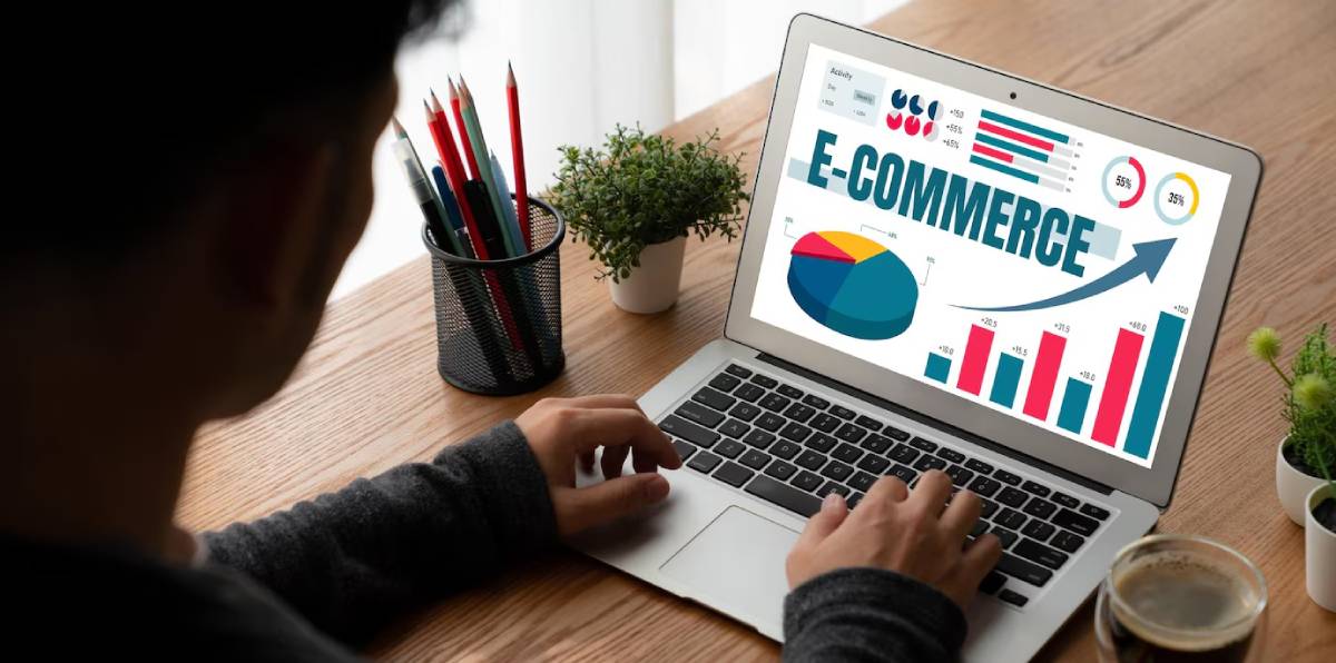 Person analyzing e-commerce data on a laptop screen with graphical representations and growth charts.