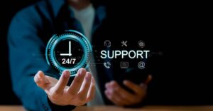 Person in a suit interacting with a holographic "24/7 Support" display, illustrating customer service availability.